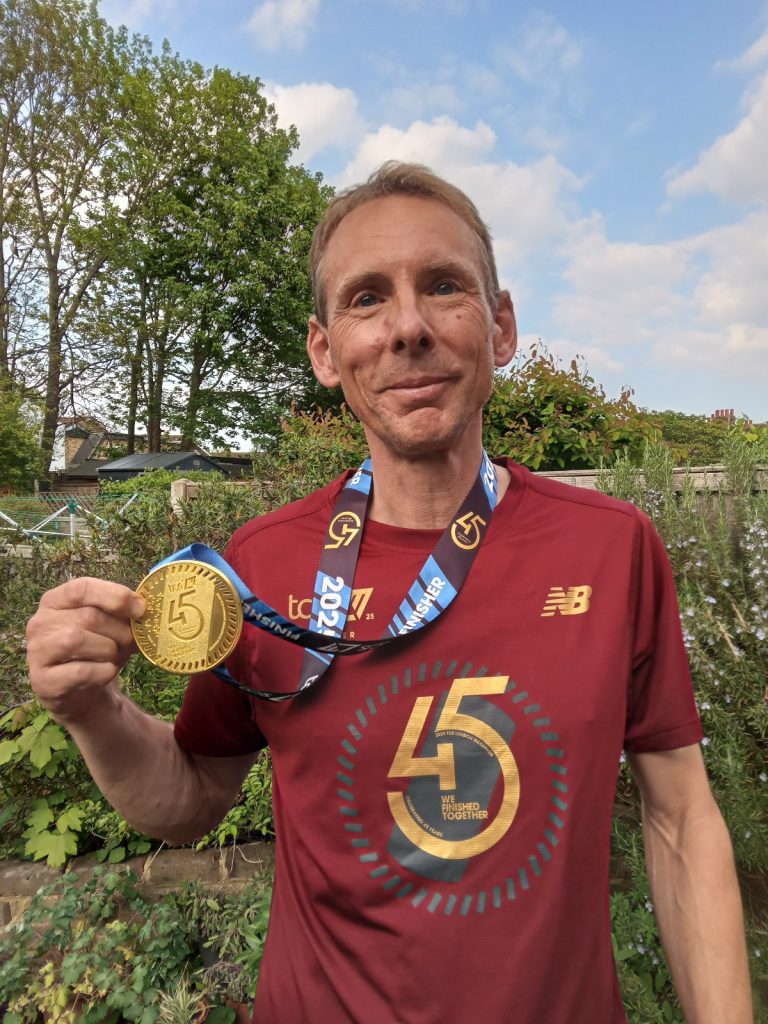 Man holding London Marathon medal